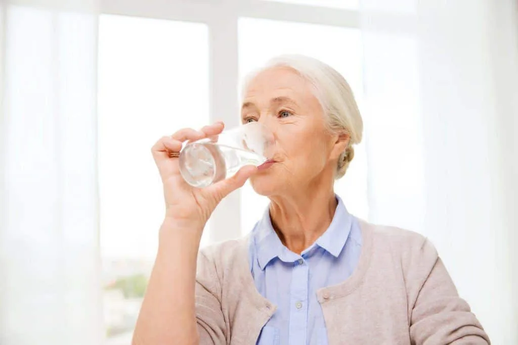elderly woman drinking water